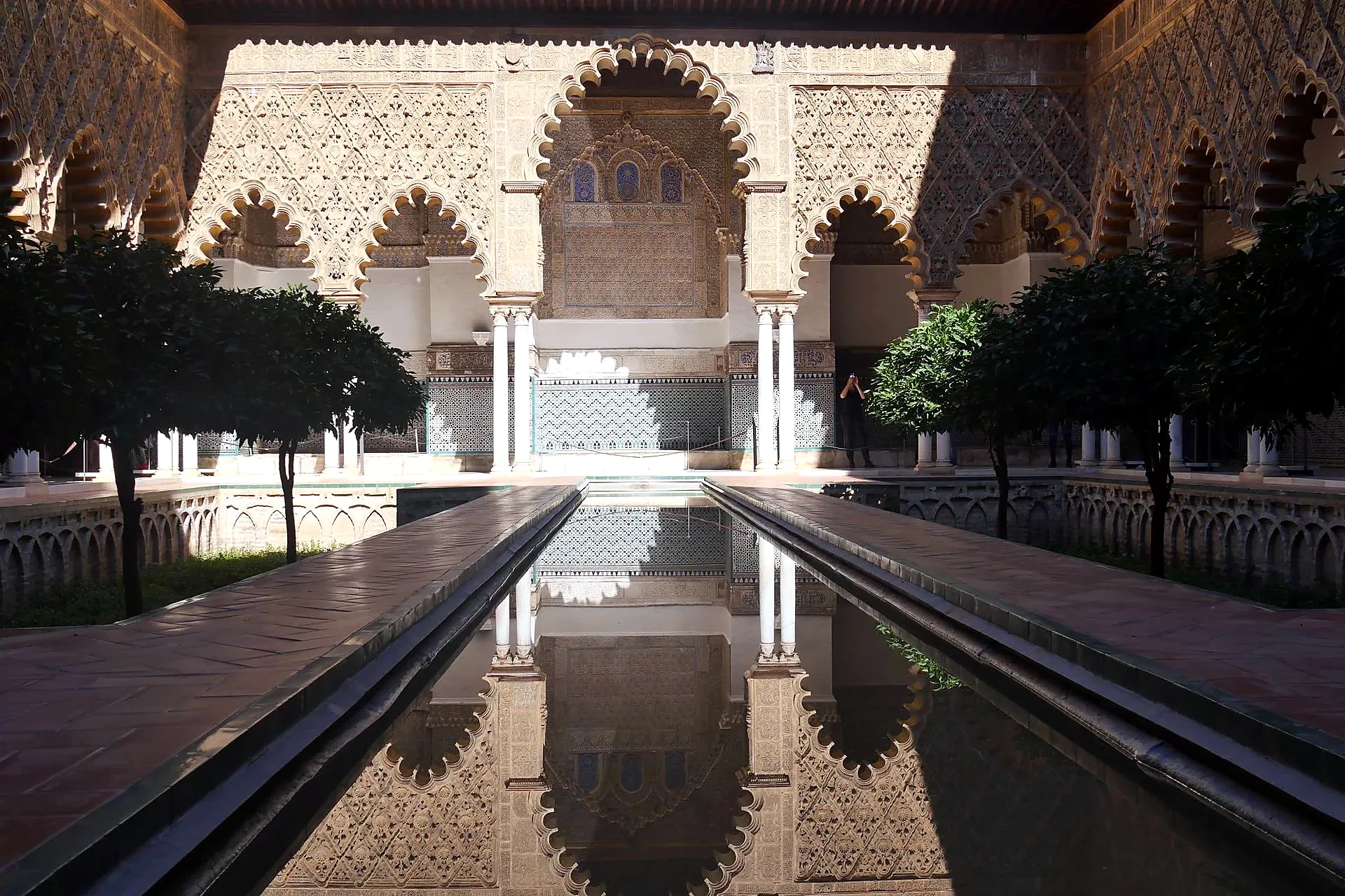 Real alcazar seville gardens arches light shadow