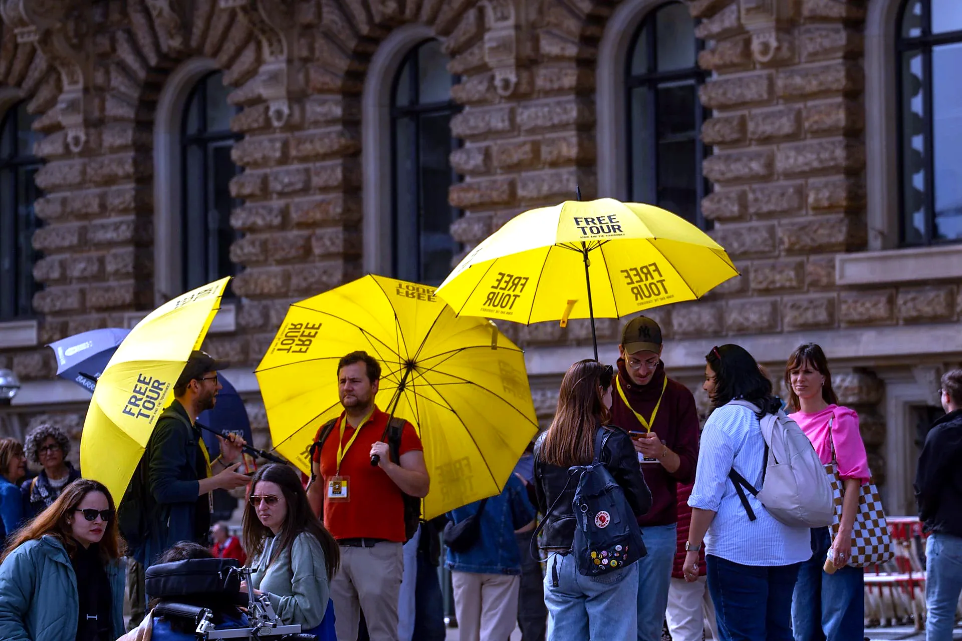 Tour guide holding umbrella marker to identify small group in Seville - Small Group Tours in Seville